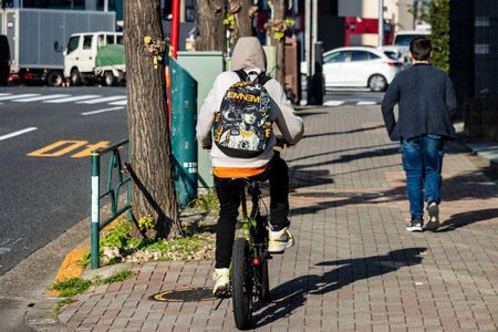 Tokyo, Japan, November 3, 2023: Cyclists and Pedestrians on a Tokyo Streetのeditorial素材