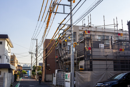 Tokyo, Japan, November 3, 2023: Construction site with scaffolding and workers in urban settingのeditorial素材