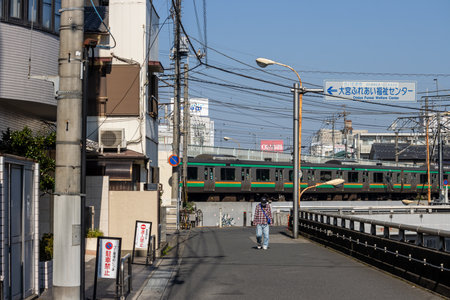 Tokyo, Japan, November 3, 2023: Train passing by residential area near Nippori stationのeditorial素材