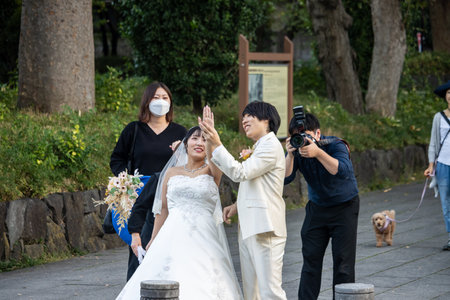 Tokyo, Japan, November 3, 2023: Wedding Photoshoot with Photographer and Bride in Maskのeditorial素材