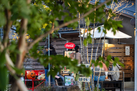 Tokyo, Japan, November 3, 2023: Outdoor seating at a local restaurant with Coca-Cola brandingのeditorial素材