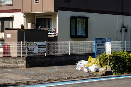 Tokyo, Japan, November 3, 2023: Residential building with a signboard and garbage collection pointのeditorial素材