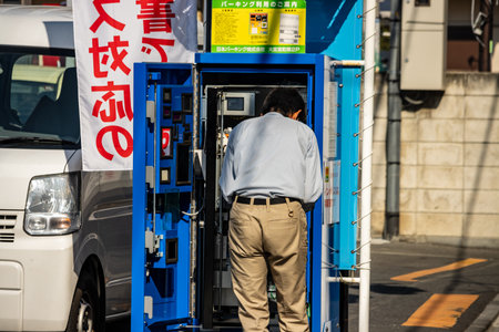 Tokyo, Japan, November 3, 2023: Engineer repairing a machine on the streetのeditorial素材
