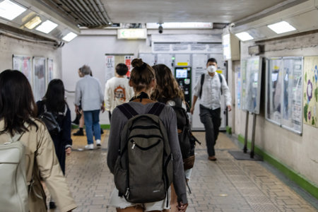 Tokyo, Japan, November 3, 2023: Commuters walking in a train station crossing