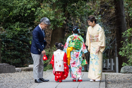 Tokyo, Japan, November 3, 2023: Traditional Japanese family in kimonos walking outdoorsのeditorial素材