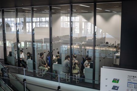 Tokyo, Japan, November 3, 2023: Patrons viewing train exhibits from a glass-enclosed walkway in the Railway Museumのeditorial素材