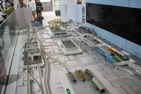 Tokyo, Japan, November 3, 2023: Visitors observing a scale model of a train station at the Railway Museumのeditorial素材