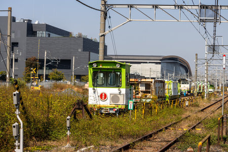 Tokyo, Japan, November 3, 2023: Vintage tram on railway tracks near a modern buildingのeditorial素材