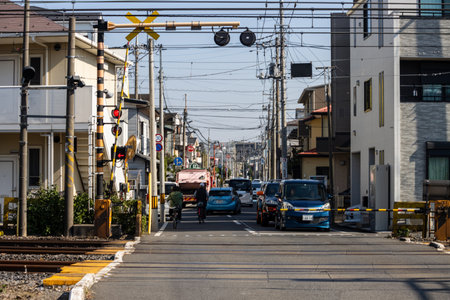 Tokyo, Japan, November 3, 2023: Traffic passing through a level crossing in a residential areaのeditorial素材