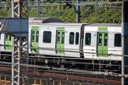 Tokyo, Japan, November 3, 2023: Yamanote Line Train Passing Through the Cityのeditorial素材