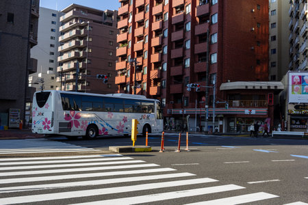 Tokyo, Japan, November 3, 2023: Bus with Colorful Advertisement on the Streetのeditorial素材