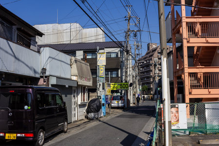 Tokyo, Japan, November 3, 2023: Alleyway in a residential area with parked vehicles and utility polesのeditorial素材