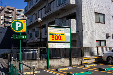 Tokyo, Japan, November 3, 2023: Automated parking lot entrance with pricing signのeditorial素材