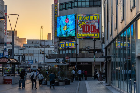 Tokyo, Japan, November 3, 2023: Crowd of people walking near shops with illuminated billboards at duskのeditorial素材