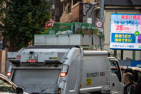 Tokyo, Japan, November 3, 2023: Garbage collection truck in urban areaのeditorial素材