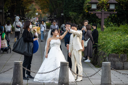 Tokyo, Japan, November 3, 2023: Couple posing for wedding photography in parkのeditorial素材