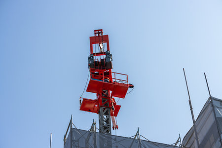 Tokyo, Japan, November 3, 2023: Construction crane against a clear blue sky