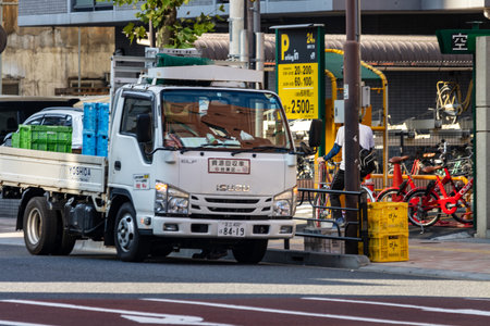 Tokyo, Japan, November 3, 2023: Delivery Truck on a Busy Street with Parking Area and Bicycles in Backgroundのeditorial素材
