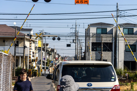 Tokyo, Japan, November 3, 2023: Street view with a Toyota vehicle and pedestrian under power lines