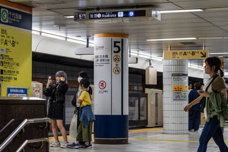 Tokyo, Japan, November 4, 2023: Commuters at Subway Station Platform Waiting for the Asakusa Line Trainのeditorial素材