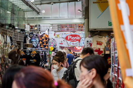 Tokyo, Japan, November 4, 2023: Bustling Shopping Street with Crowds and Colorful Storefronts in Tokyoのeditorial素材