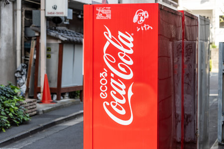 Tokyo, Japan, November 4, 2023: Vibrant Coca-Cola Vending Machine on a Tokyo Street