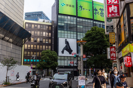 Tokyo, Japan, November 4, 2023: Bustling Street Scene with Prominent Fashion Billboards