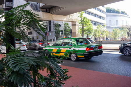 Tokyo, Japan, November 4, 2023: Green and Yellow Taxi on the Streets of Tokyoのeditorial素材