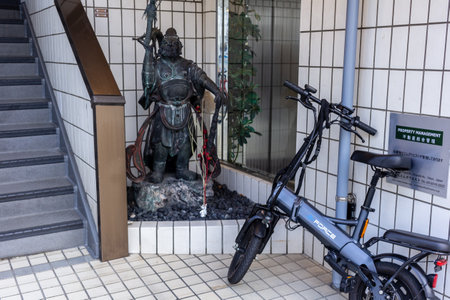 Tokyo, Japan, November 4, 2023: Foldable Electric Bicycle Parked Outside an Office Buildingのeditorial素材
