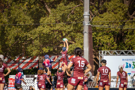 Tokyo, Japan, November 4, 2023: Dynamic Women's Rugby Match with Team in Maroon Jerseysのeditorial素材
