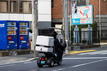 Tokyo, Japan, November 4, 2023: Security Patrol Vehicle in Motion on a Busy Tokyo Streetのeditorial素材