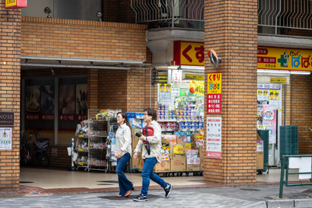 Tokyo, Japan, November 4, 2023: Pedestrians Walking Past a Traditional Japanese Drugstoreのeditorial素材
