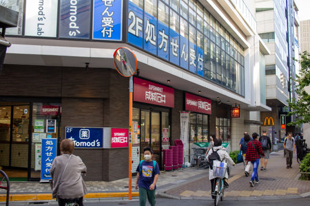 Tokyo, Japan, November 4, 2023: Daily Life Scene with Diverse Businesses and Pedestrians in Tokyo