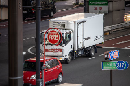Tokyo, Japan, November 4, 2023: Delivery Truck from SFC Line Navigating Through Busy Tokyo Traffic