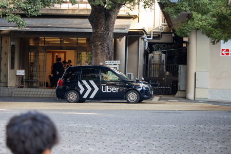 Tokyo, Japan, November 4, 2023: Uber Vehicle Providing Transportation Services in Urban Settingのeditorial素材