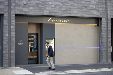 Tokyo, Japan, November 4 2023: Businessman walking past a modern golf store