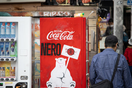 Tokyo, Japan, November 4 2023: Vending machine beside graffiti wallのeditorial素材