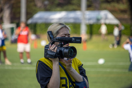 Tokyo, Japan, November 4 2023: Female Photographer Capturing Sports Event