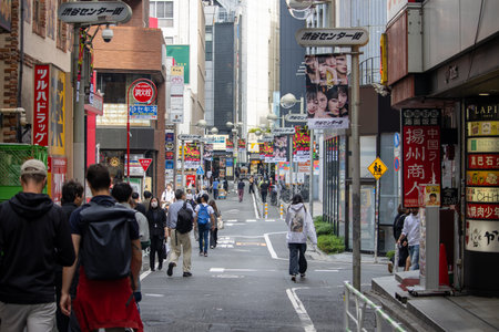 Tokyo, Japan, November 4, 2023: Bustling street scene with pedestrians and shopsのeditorial素材