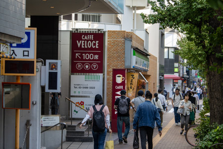 Tokyo, Japan, November 4, 2023: Bustling Street Scene with Pedestrians and CafÃ© Veloce Signのeditorial素材