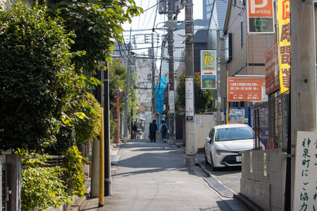 Tokyo, Japan, November 4, 2023: Urban Street Scene with Pedestrians and Commercial Signageのeditorial素材
