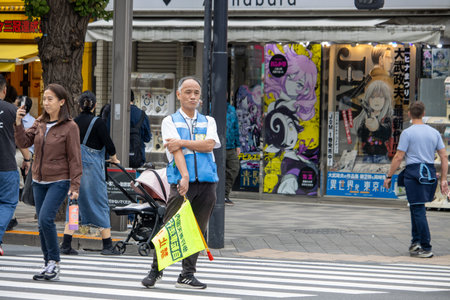 Tokyo, Japan, November 5, 2023: Urban street scene with pedestrians and advertising signsのeditorial素材