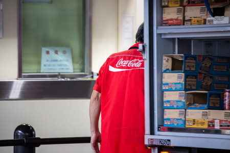 Tokyo, Japan, November 5 2023: Coca-Cola Employee in Storage Roomのeditorial素材