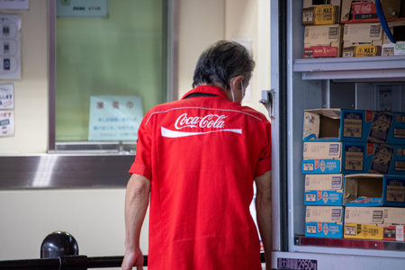 Tokyo, Japan, November 5 2023: Coca-Cola Employee in a Storage Roomのeditorial素材