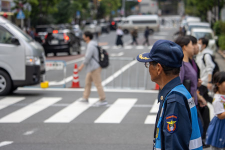 Tokyo, Japan, November 5, 2023: Security guard monitoring pedestrian traffic in Shibuyaのeditorial素材