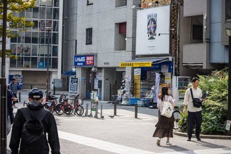 Tokyo, Japan, November 5 2023: Everyday street scene with pedestrians and local businessesのeditorial素材