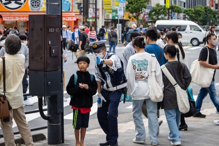 Tokyo, Japan, November 5 2023: Street scene with police officers and pedestriansのeditorial素材