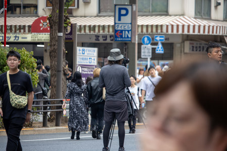 Tokyo, Japan, November 5 2023: Photographer capturing street life in a busy districtのeditorial素材