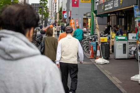 Tokyo, Japan, November 5 2023: Pedestrians Walking on a Busy Street with Storesのeditorial素材