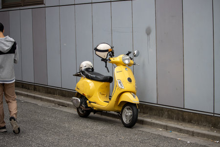 Tokyo, Japan, November 5 2023: Yellow scooter parked on the streetのeditorial素材